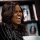 Michelle Obama laughs while signing copies of her new book ‘Becoming’ during a book signing event at a Barnes & Noble bookstore, November 30, 2018 in New York City.